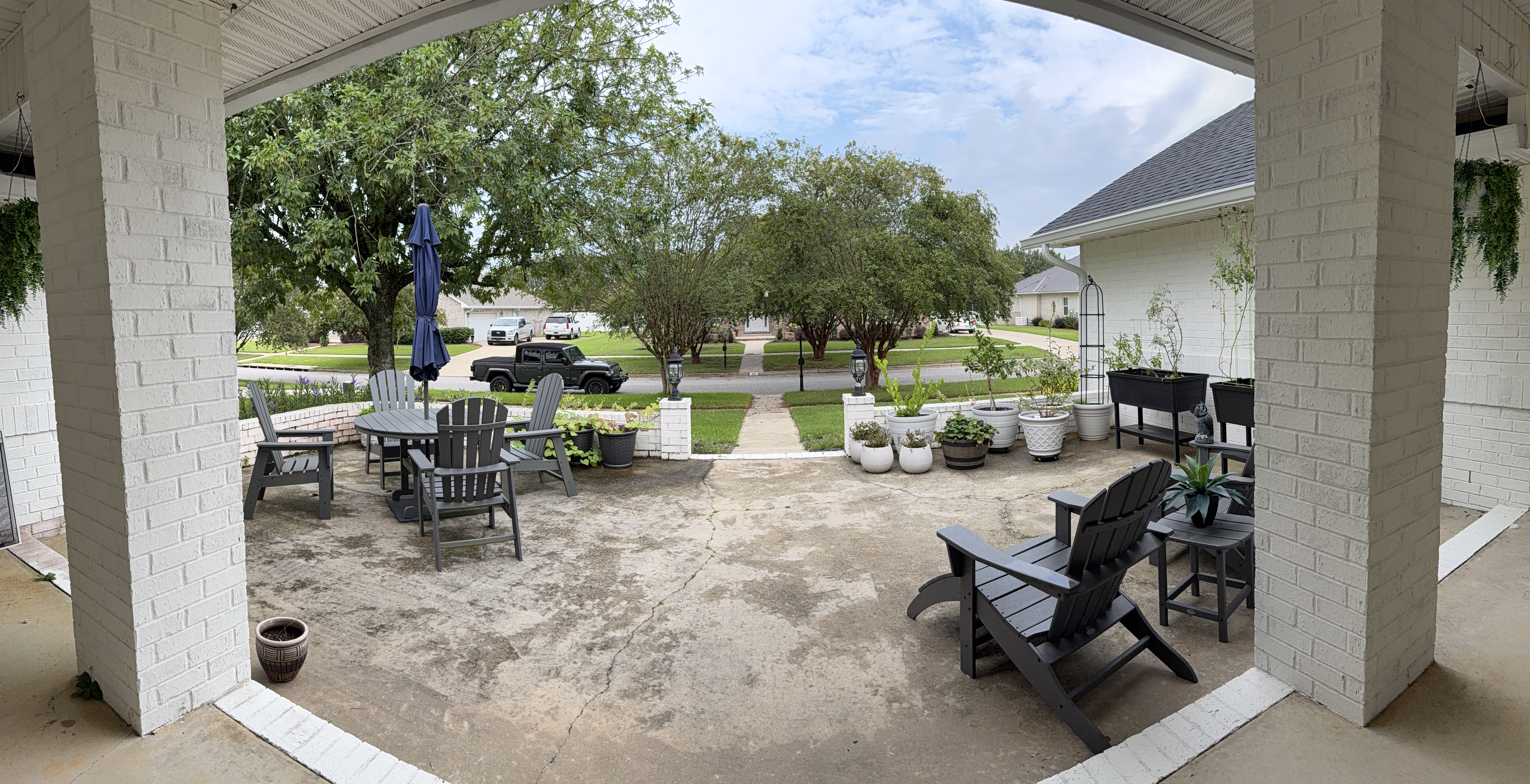 Concrete courtyard with dark surface buildup before pressure washing