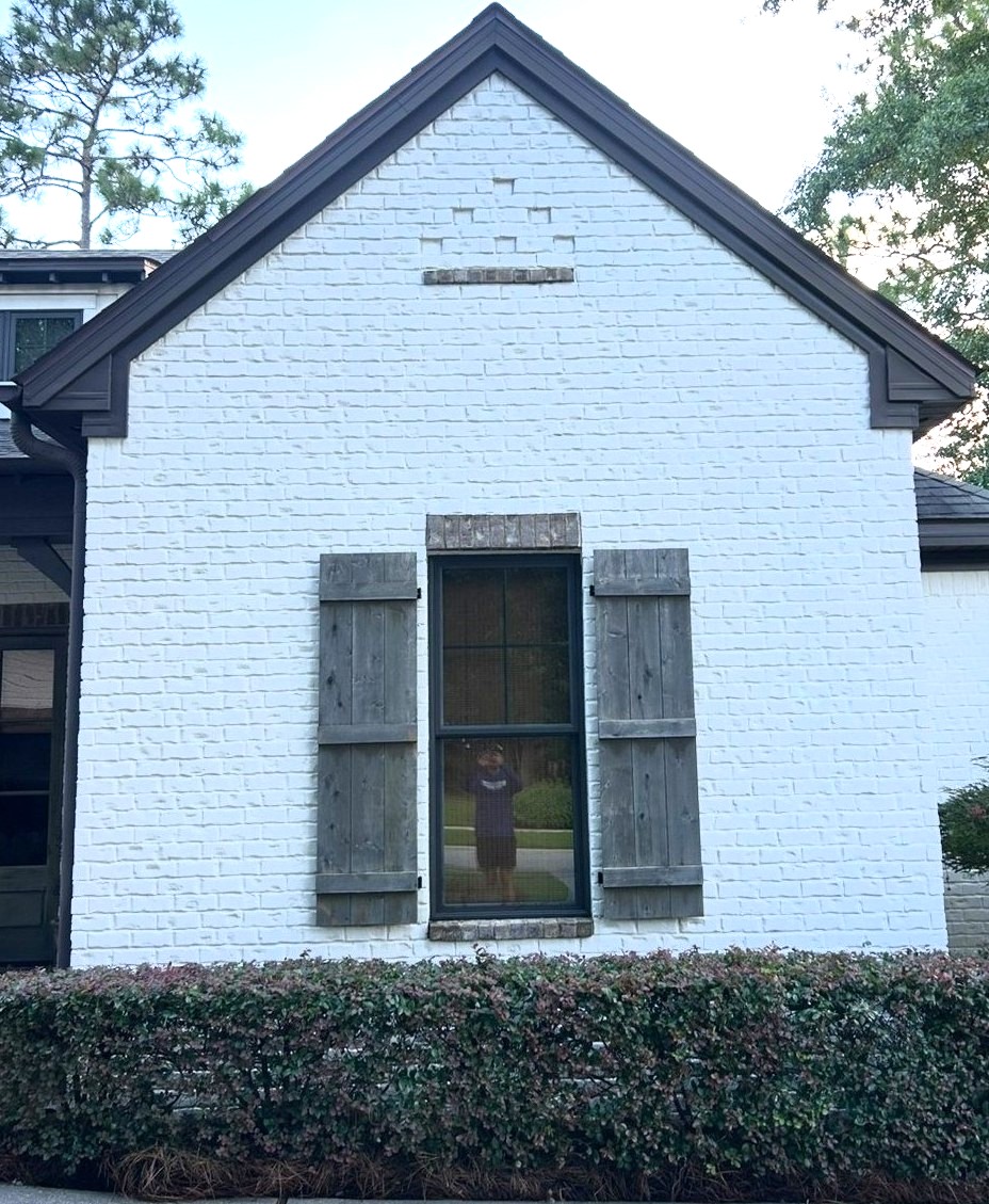Before soft washing of a stained house exterior in Pensacola