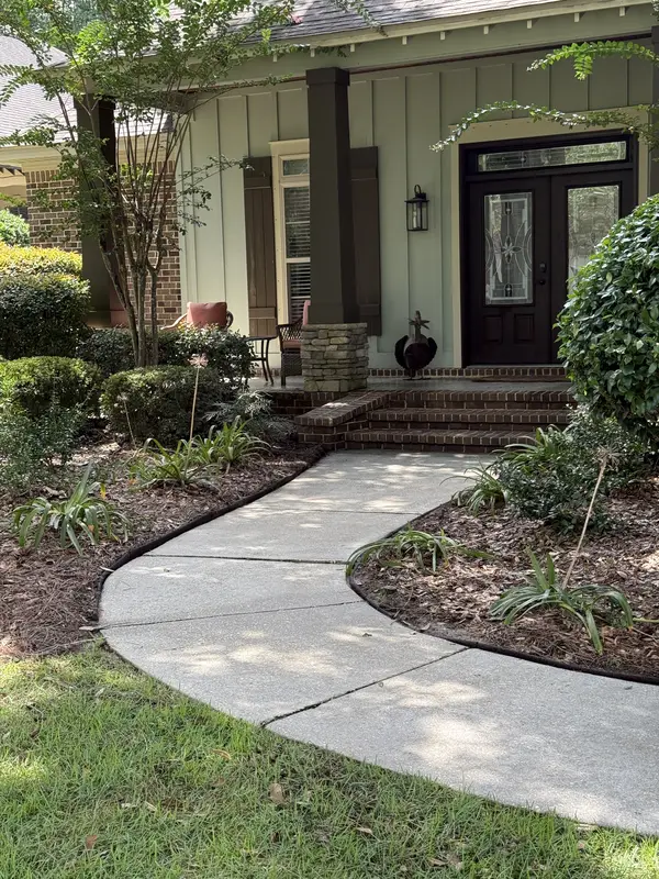 Curved concrete walkway and front entry after pressure washing