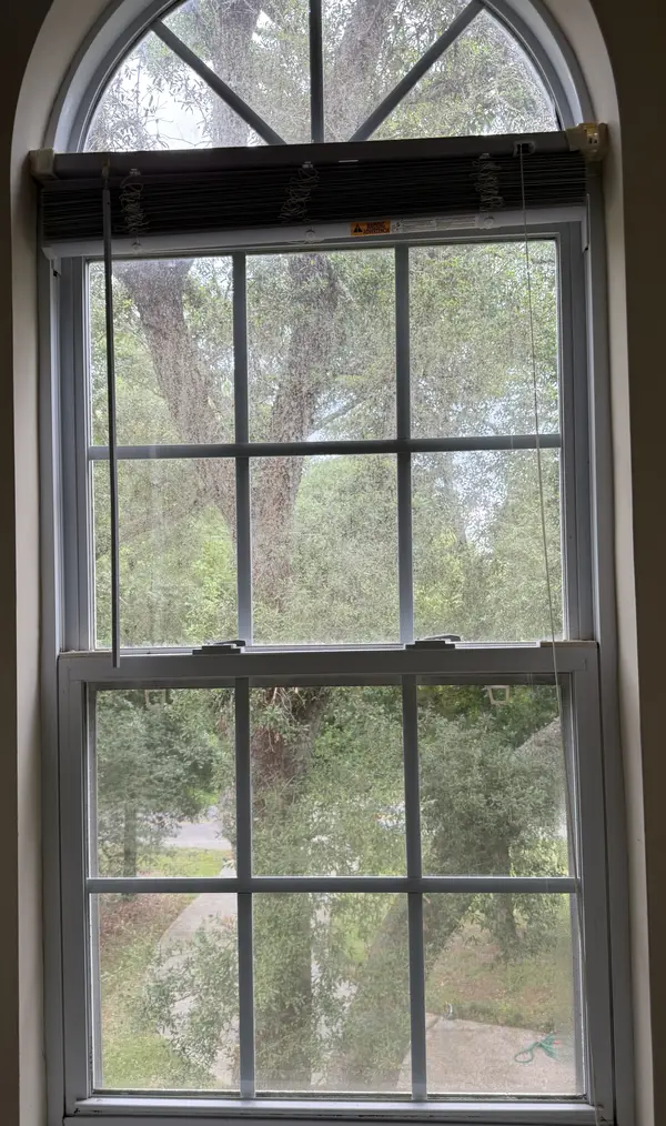 Before interior window cleaning with cloudy buildup on the window