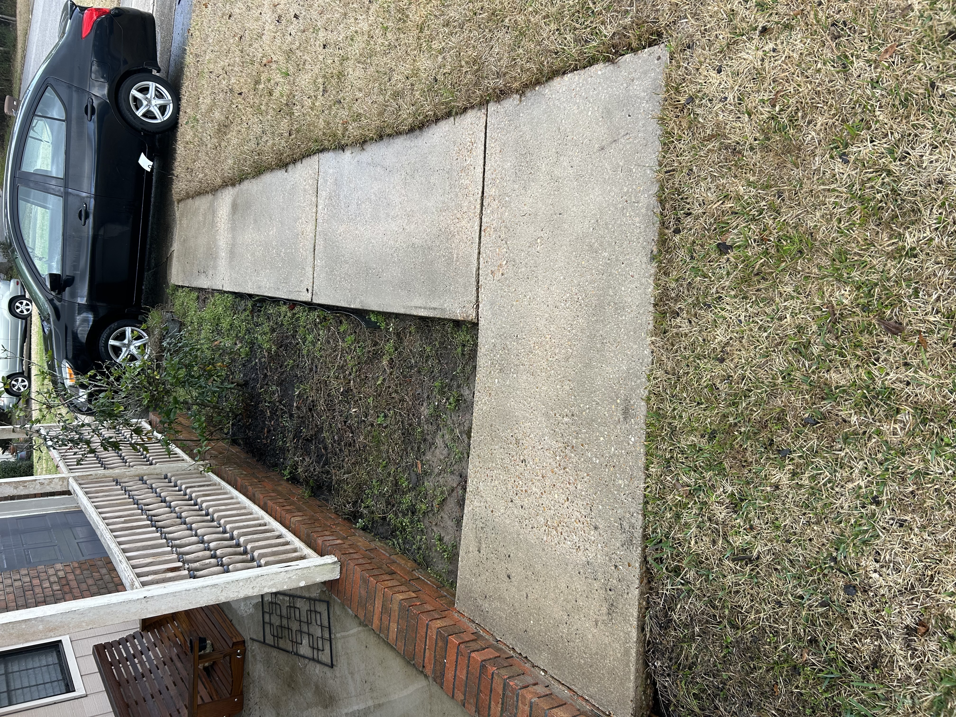 After walkway pressure washing with a brighter surface in Pensacola