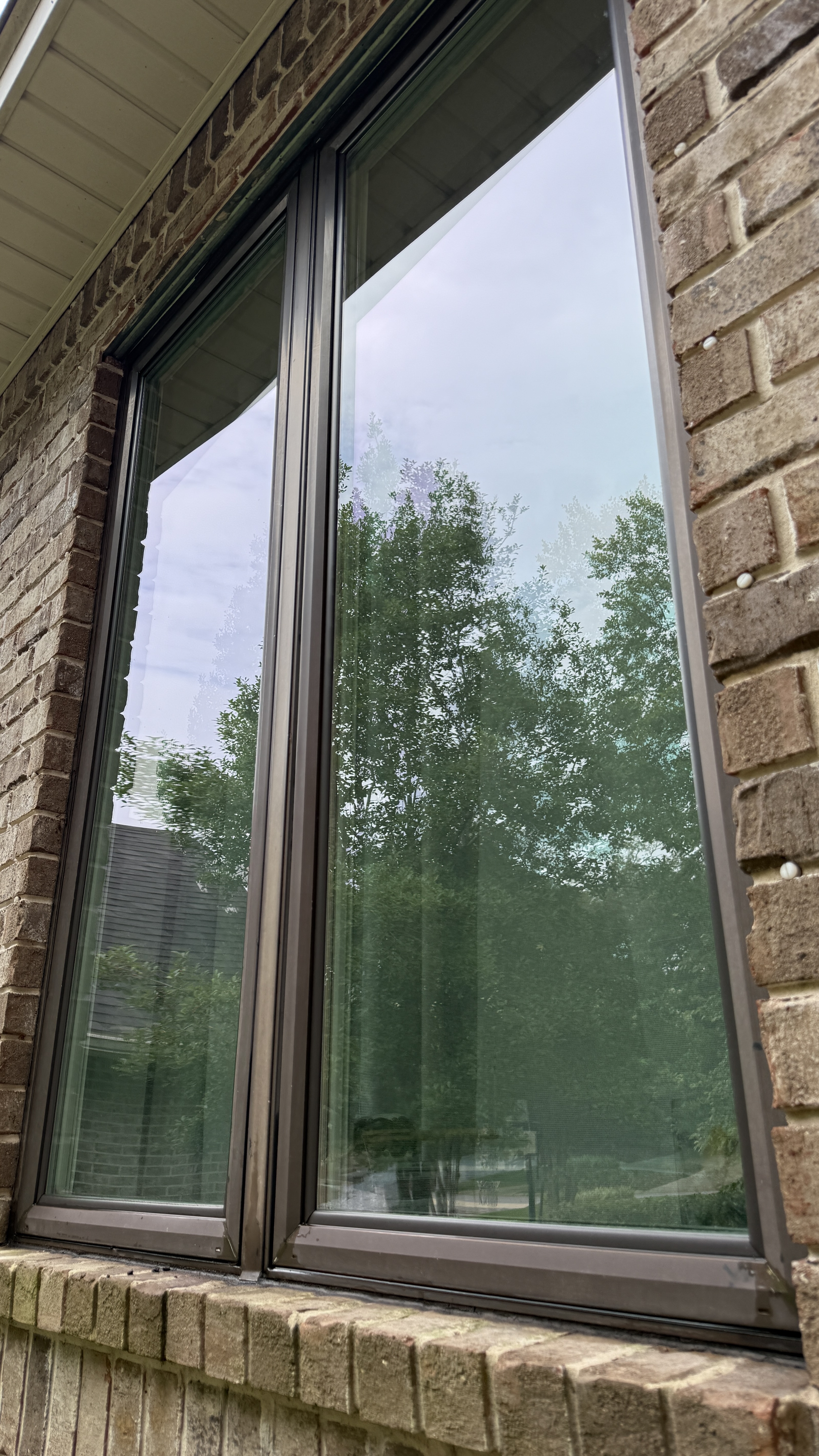 Clean windows after exterior window washing at a brick home in Pensacola Florida